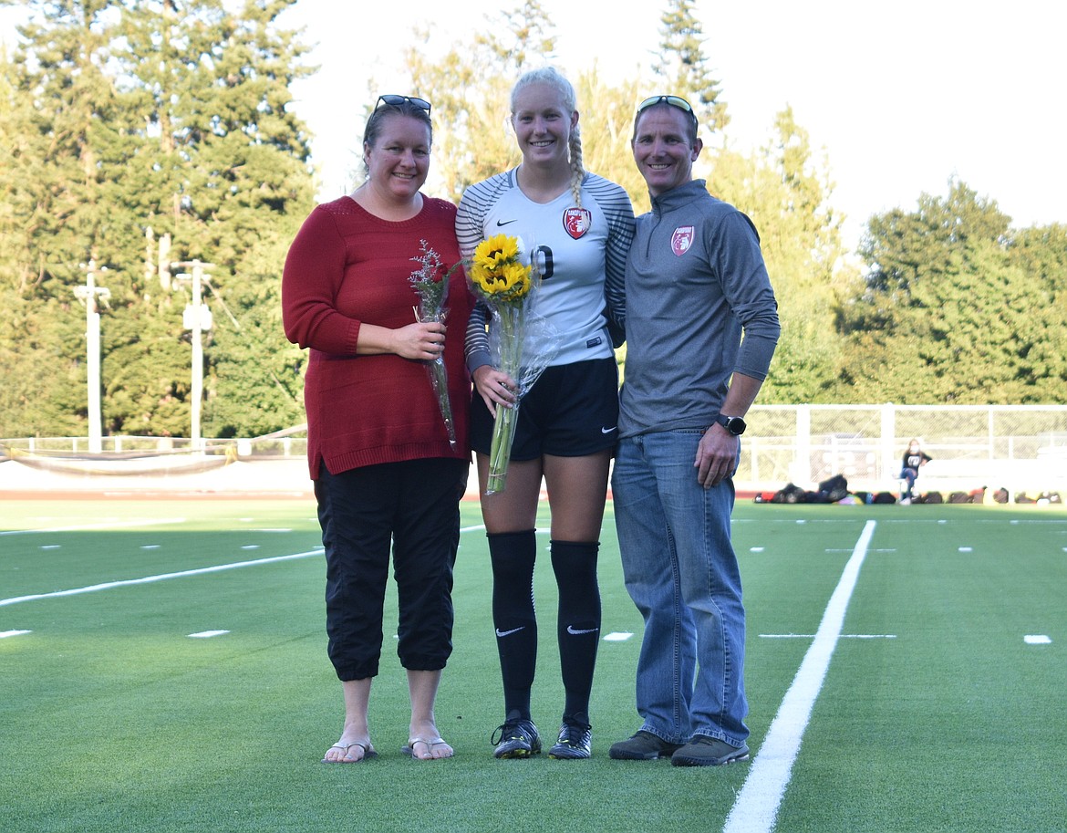 Hattie Larson poses for a photo with her family on senior night.
