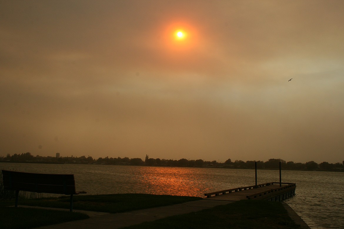 Smoke hangs over Moses Lake Monday evening. Smoky conditions are expected to linger as fires continue to burn in Eastern Washington.