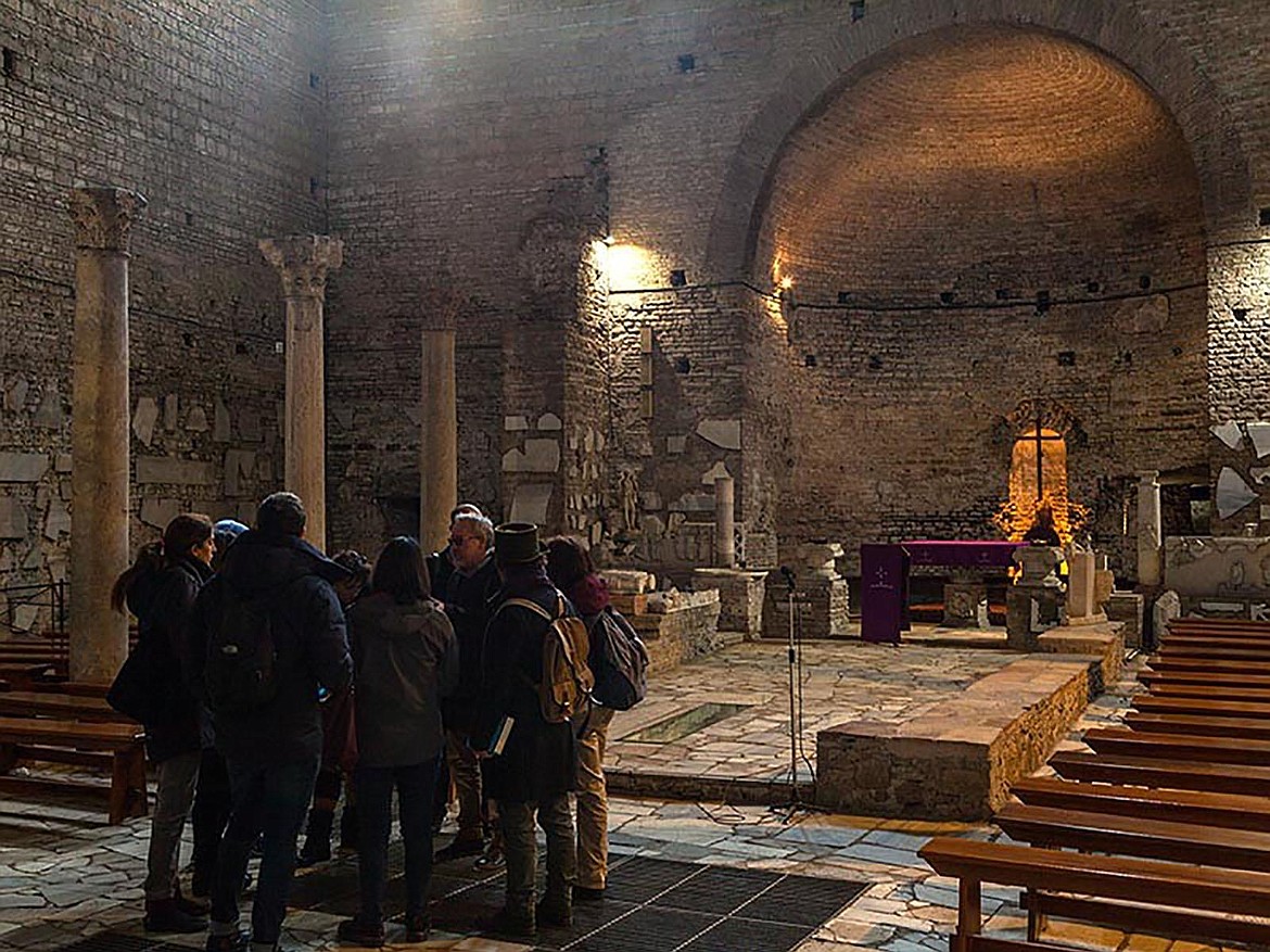 Tour visitors shown here are in the basilica in St. Domatilla Catacomb, the only basilica in any of Rome’s catacombs; this one dedicated to the martyrs Nereo, Achilleo and Saint Petronilla, daughter of St. Peter.