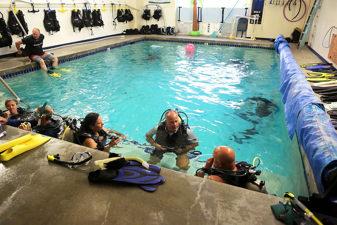 Instructor Mike Ferda teaches veterans how to scuba dive during an evening dive night with Underwater Soldiers.
(Mackenzie Reiss/Daily Inter Lake)