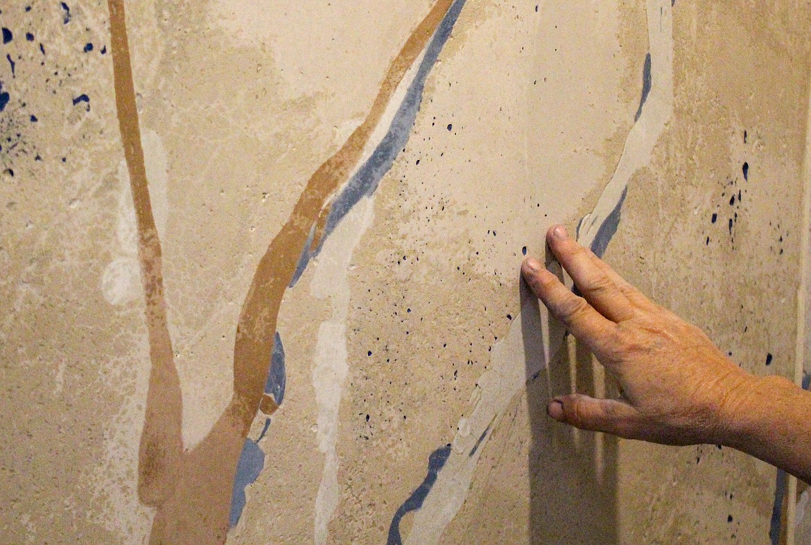 Christina Arnall, co-owner of D.C. Custom Construction Inc. out of Quincy, showcases the multi-colored concrete shower recently installed at a home remodel project her company is working on in Quincy.