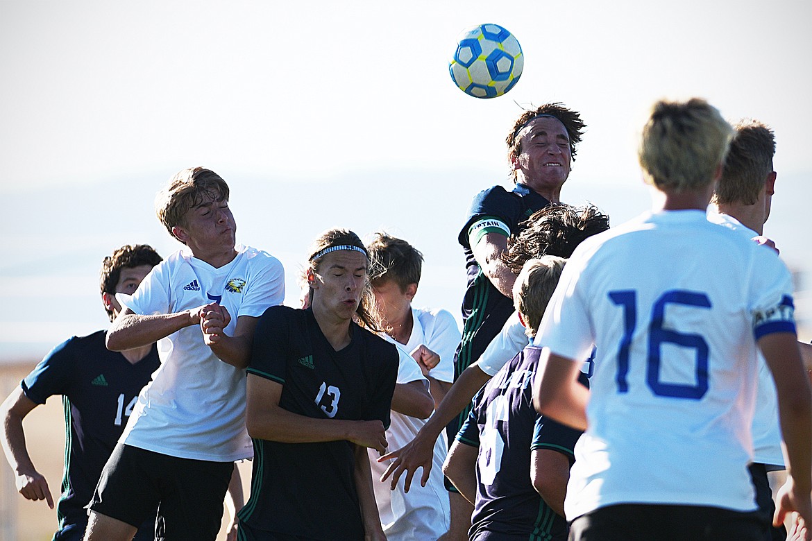 Glacier’s Braden Nitschelm (25) battles for a header in the Missoula Big Sky zone in the first half at Glacier High School on Thursday. (Casey Kreider/Daily Inter Lake)
