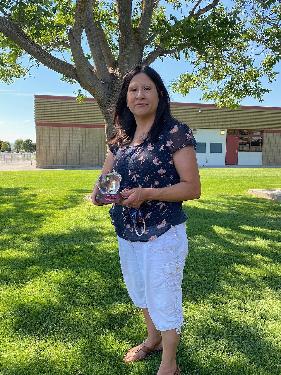 Alicia Cantu holds up the Crystal Apple, which was presented to her after 30 years of service to the Wahluke School District.
