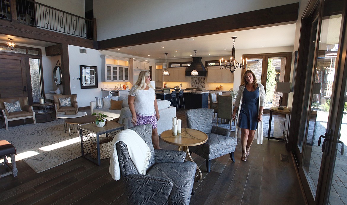 Leslie Streeter of the North Idaho Building Contractors Association, left, and Shawn Anderson of Monarch Custom Homes, walk through "Riverside Retreat"at 4735 W. Mill River Court. The home will be featured in NIBCA's Parade of Homes that begins Saturday.