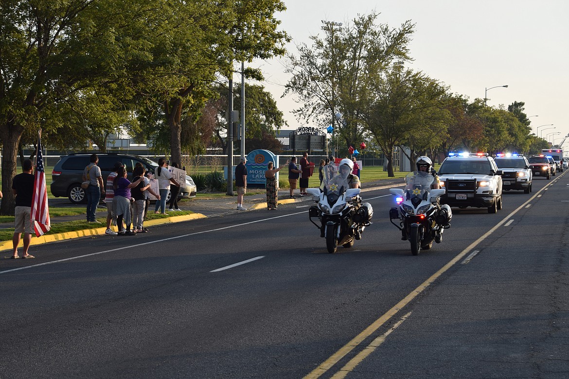The motorcade of local, county and state law enforcement vehicles bearing the body of Andrew Deering, a Moses Lake firefighter who died as a result of an accident over Labor Day weekend, makes its way slowly up S. Broadway late Friday afternoon.
