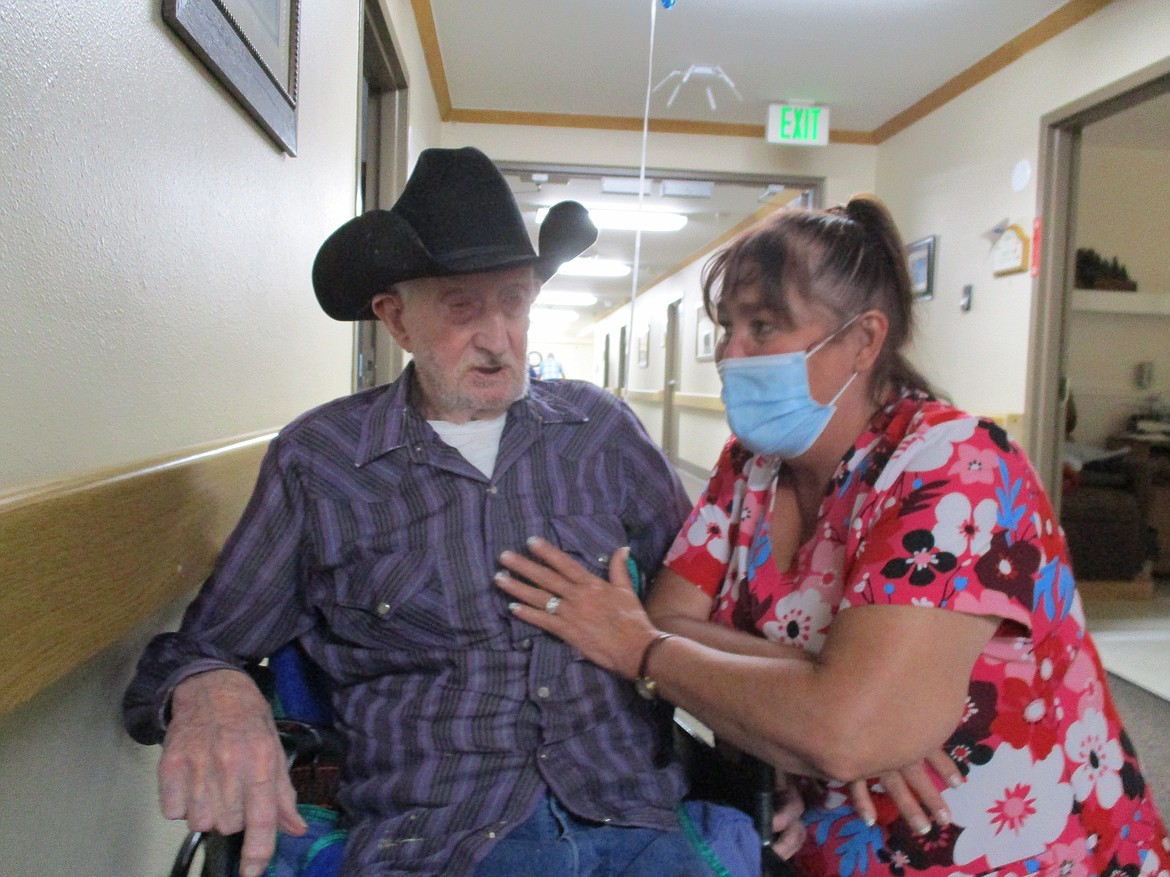 Arnie, left, gets a hug from a staffer at Valley Vista Assisted Living. The Sandpoint facility is mounting an effort to get community members to adopt residents for National Grandparents Day on Sunday.