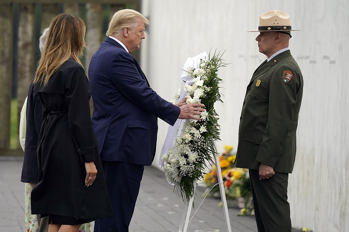 President Donald Trump lays a wreath at a 19th anniversary observance of the Sept. 11 terror attacks, at the Flight 93 National Memorial in Shanksville, Pa., Friday, Sept. 11, 2020. (AP Photo/Alex Brandon)