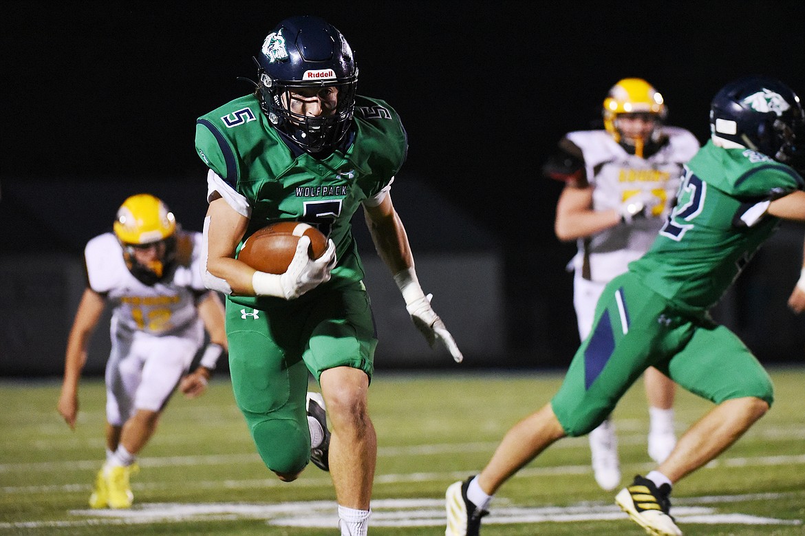 Glacier wide receiver Cole Johnson (5) heads upfield after a third quarter reception against Helena Capital at Legends Stadium on Friday. (Casey Kreider/Daily Inter Lake)