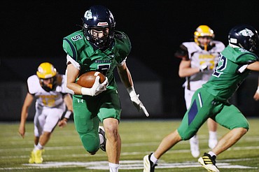 Glacier wide receiver Cole Johnson (5) heads upfield after a third quarter reception against Helena Capital at Legends Stadium on Friday. (Casey Kreider/Daily Inter Lake)