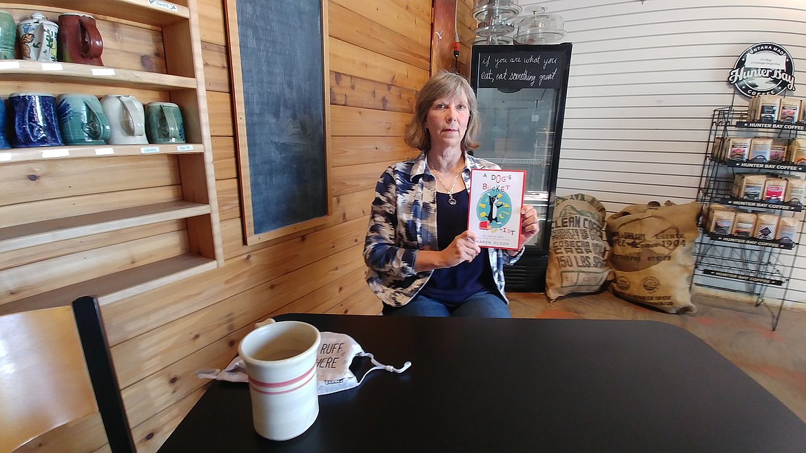 Plains author Karen Olson displays her recently published book. (Chuck Bandel/Valley Press)