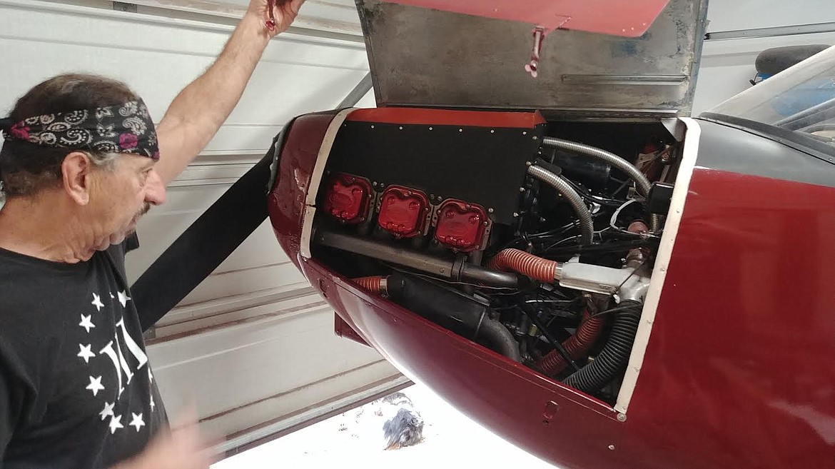 Ned Beigney checks the rebuilt engine of the vintage 1947 Stinson 108 model plane. (Chuck Bandel/Valley Press)