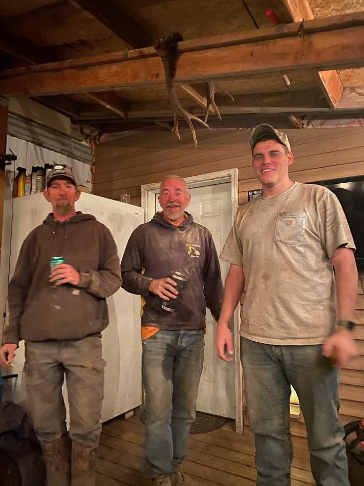 Sometimes all you can do is smile. (From left) Bill Anundson, Ron Horn and Nick Cameron — Anundson's soon-to-be son-in-law — share a laugh Thursday night over how clean the Blanchard fire left them. "They basically were watching each other's backs the whole time," Kristina Logue said, "stopped for a cold one and laughed about how dirty they were." Despite losing his home in the fire, Anundson kept his spirits up while he helped support the community, locals say. (Photo by Bunny Horn)