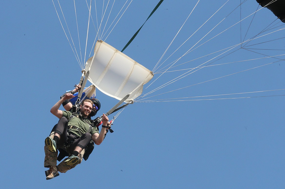 Nathan Newby rides with DZONE Skydiving professional Derreck Sfachios Fischer during a commemorative skydive experience Friday at the Coeur d'Alene Airport.