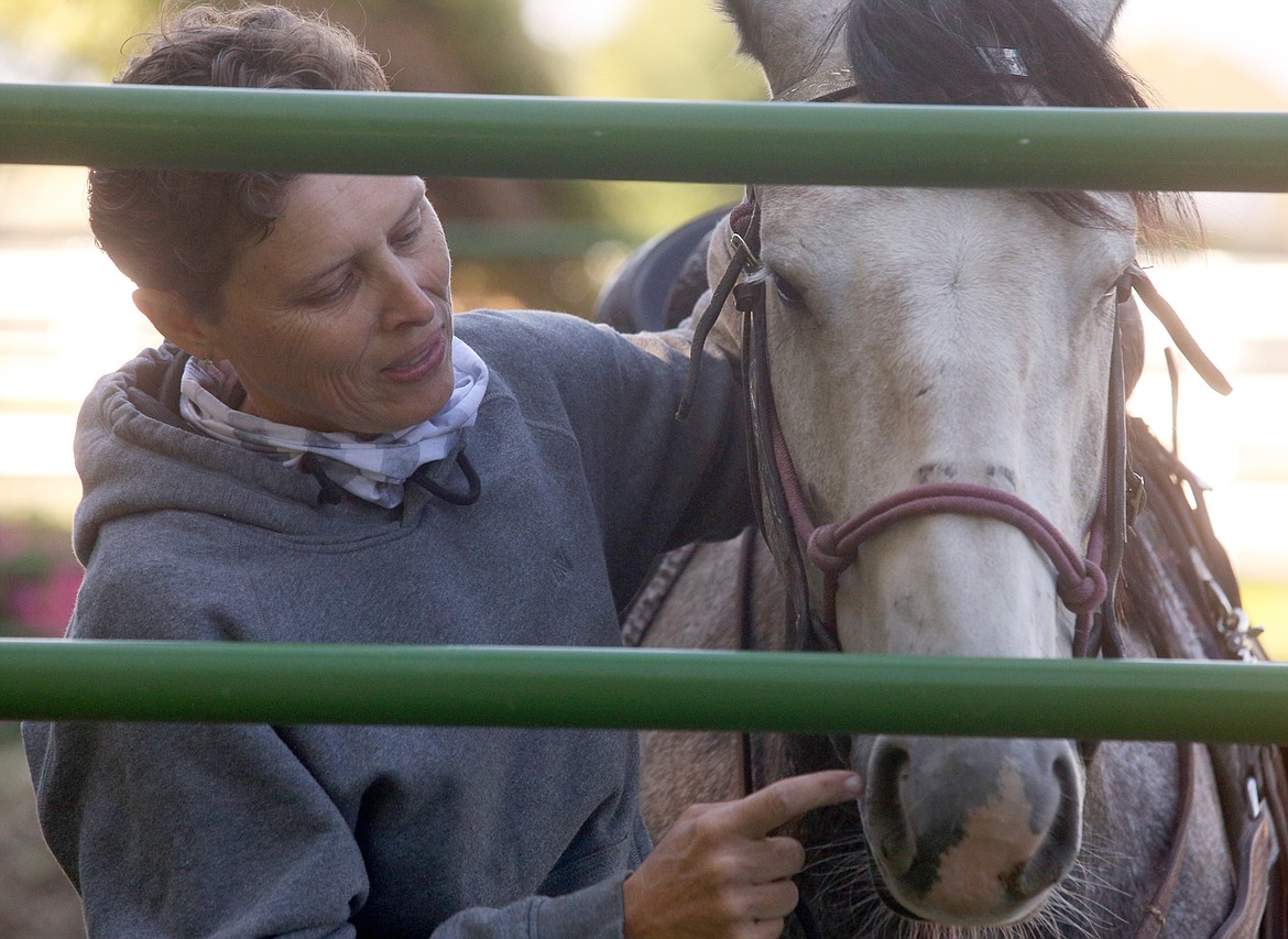 Suzette Brownell shares a moment with Codi after a training session at Running W Therapeutic Riding Center.