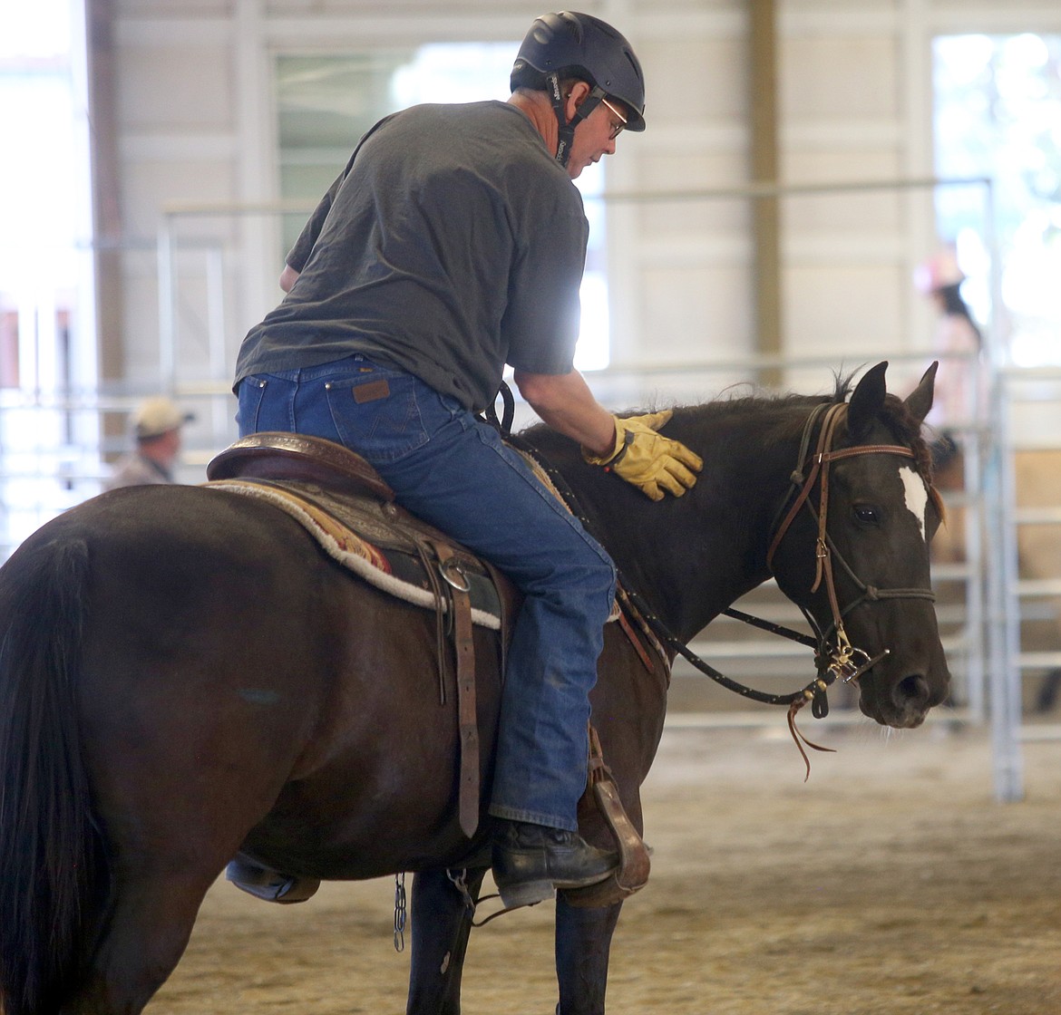 Randy Voll pats Odina during a break Thursday.