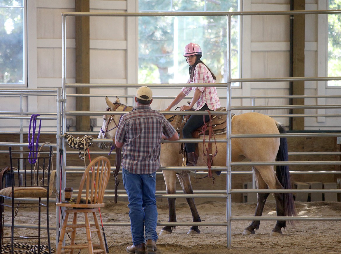 Don Wiltsie watches Autumn Galey ride Kalehi as they train together on Thursday.