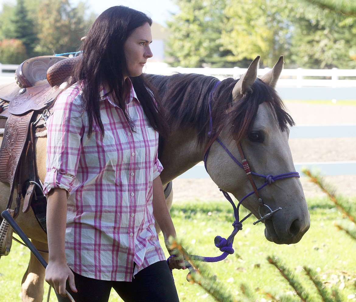 Autumn Galey and Kaleki walk back to the indoor arena at Running W Therapeutic Riding Center.