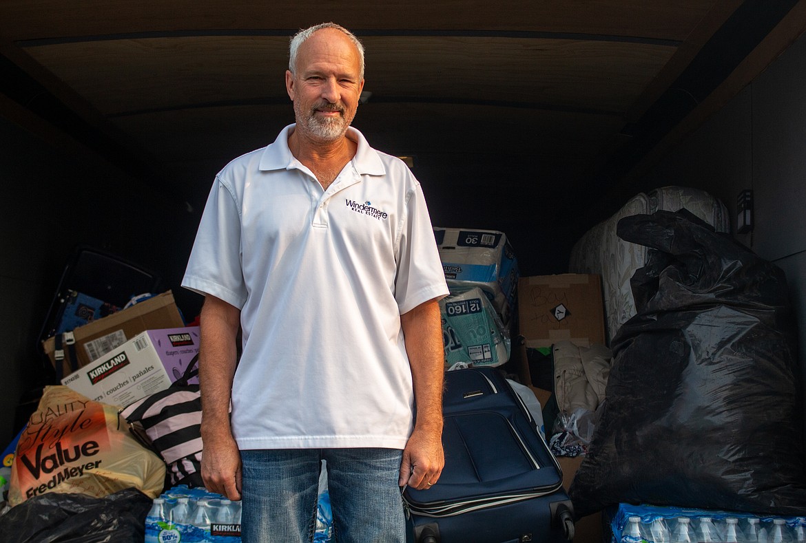 Kevin Burgess stands in front of his trailer loaded with donations he's gathered from people in the community to be delivered to individuals affected by the wildfires around Malden, Washington earlier this week.
