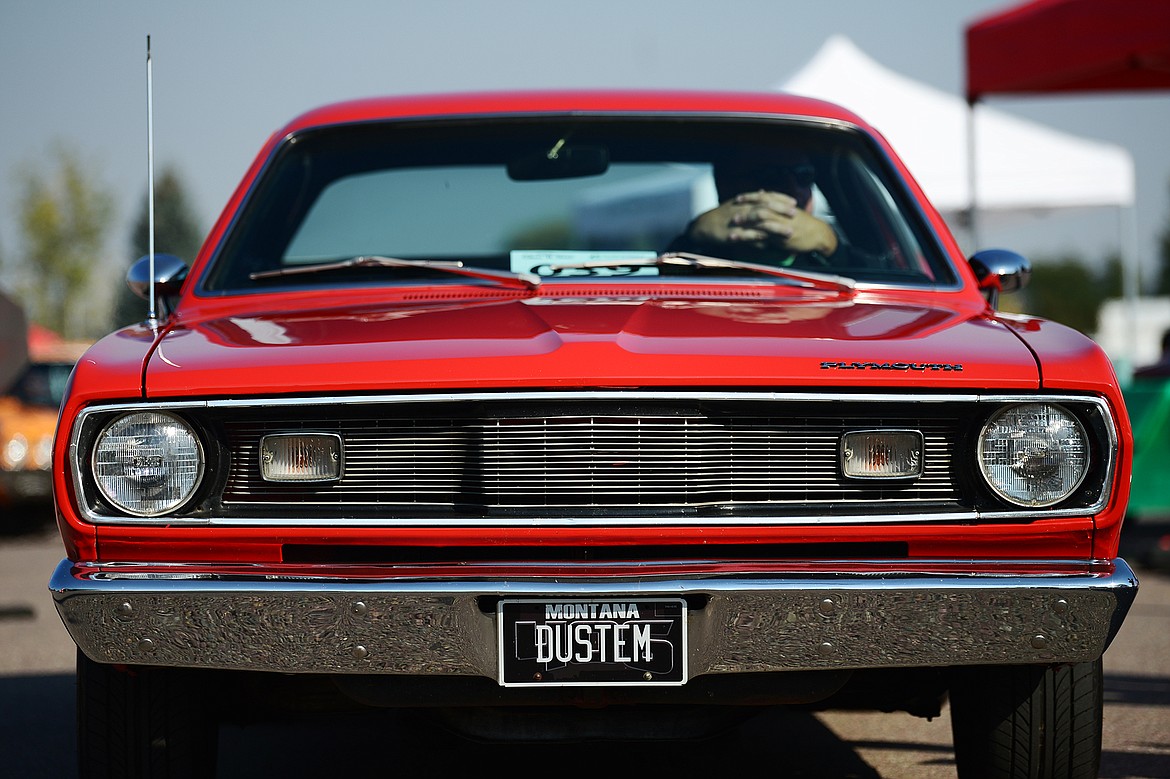 Chad Fincher drives his 1971 Plymouth Duster through the Evergreen Show ’N Shine virtual car show at Conlin’s Furniture on Saturday.  (Casey Kreider/Daily Inter Lake)