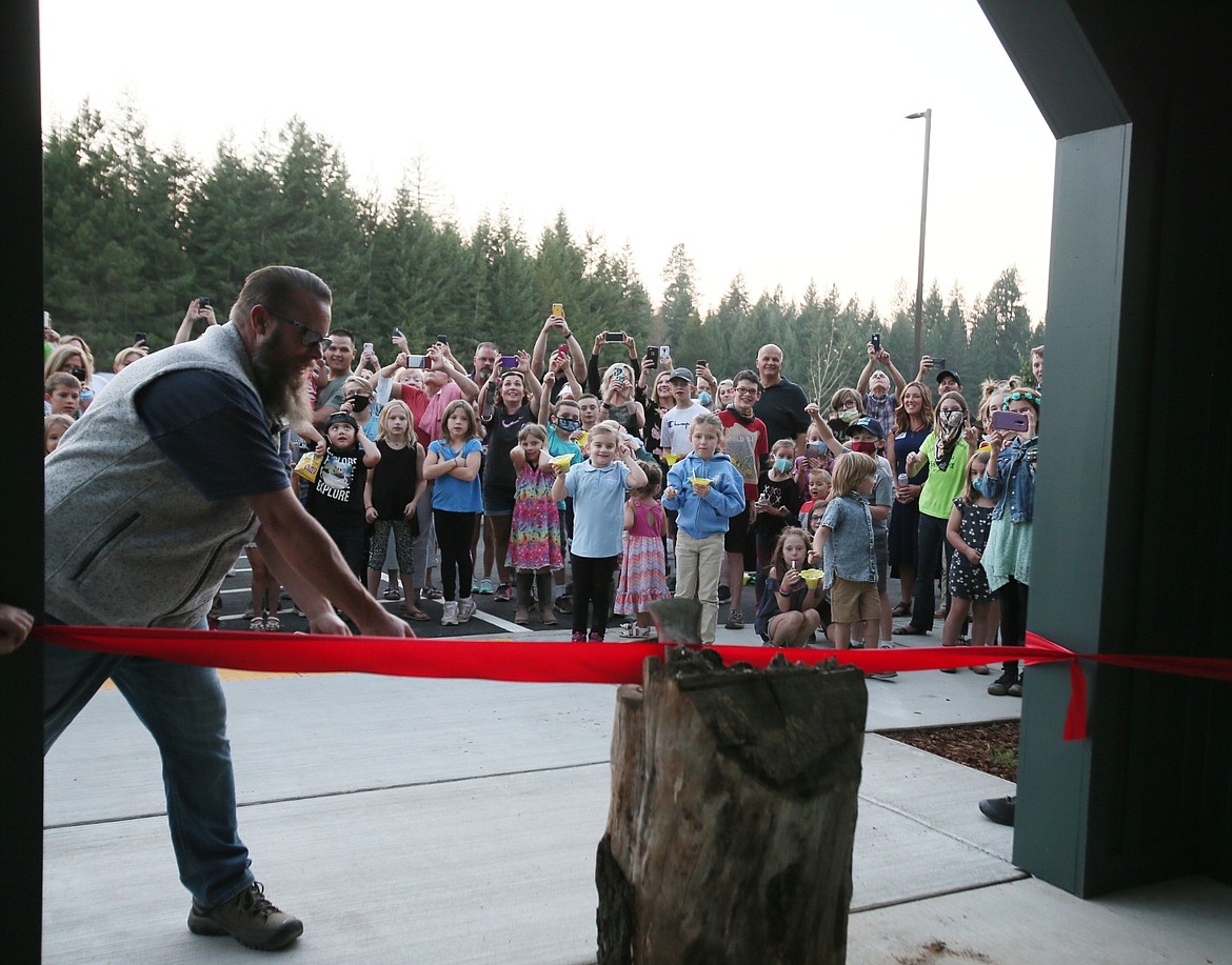 The crowd goes wild as Tyson Schroeder, vice chair of the Hayden Canyon Charter School board, cuts the ceremonial red ribbon to officially open the school Friday evening. Hayden Charter will welcome its first year of students on Sept. 21.