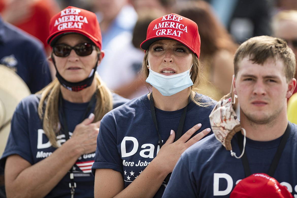 Attendees of the Republican campaign rally for for Sen. Steve Daines, R-Mont., and attended by Vice President Mike Pence say the pledge of allegiance in Belgrade, Mont. on Monday, Sept. 14, 2020. (AP Photo/Tommy Martino)