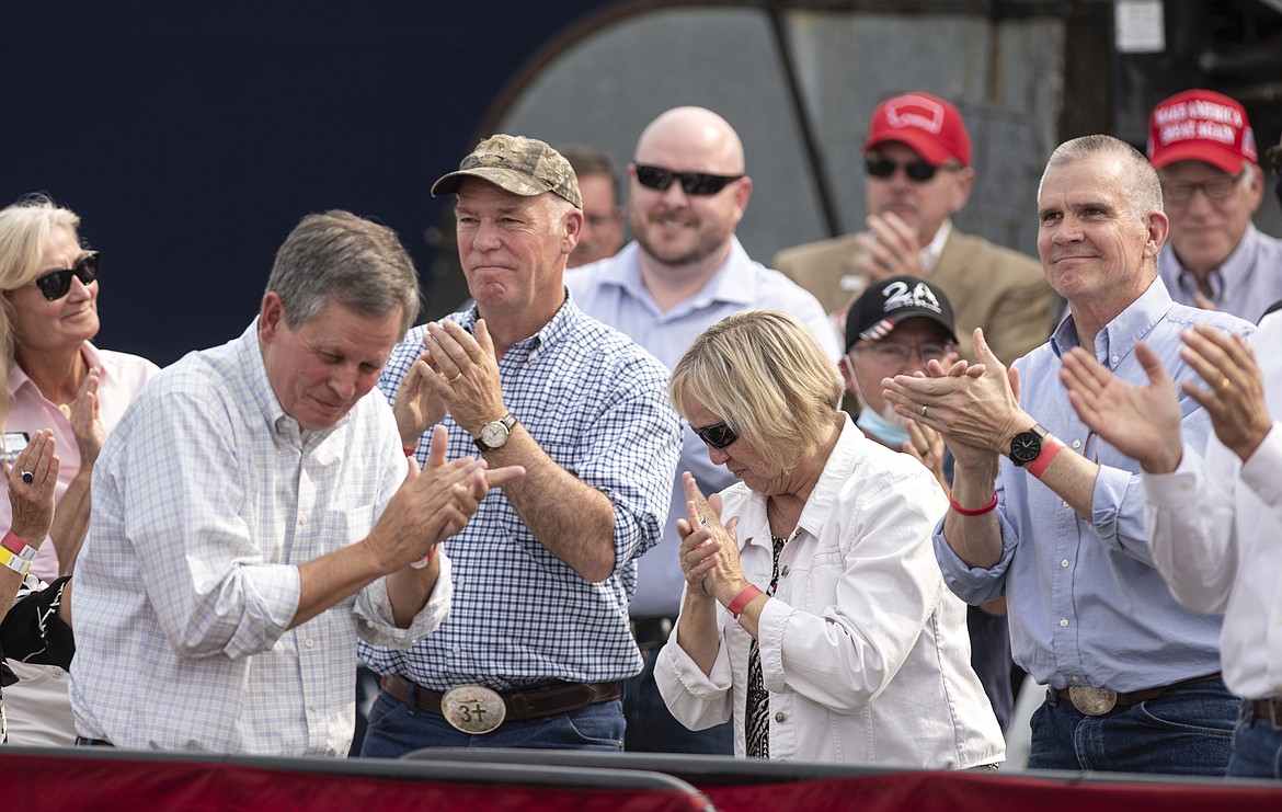 Sen. Steve Daines, R-Mont., from left, Rep. Greg Gianforte, R-Mont., center, a Republican running for governor, and state auditor Matt Rosendale clap during Vice President Mike Pence's speech at a Republican campaign rally in Belgrade, Mont., on Monday, Sept. 14, 2020. (AP Photo/Tommy Martino)