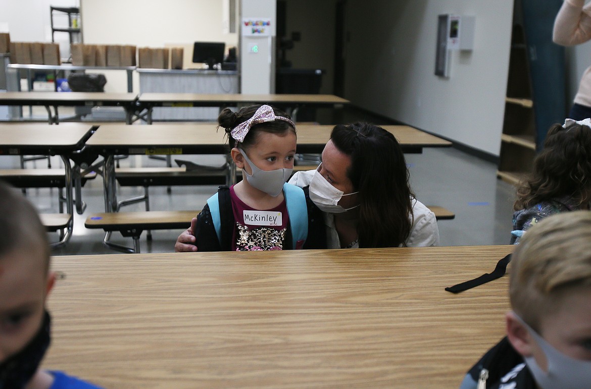 Irene Kloos comforts daughter McKinley Kloos as she starts her first day of kindergarten at Northwest Expedition Academy on Monday.