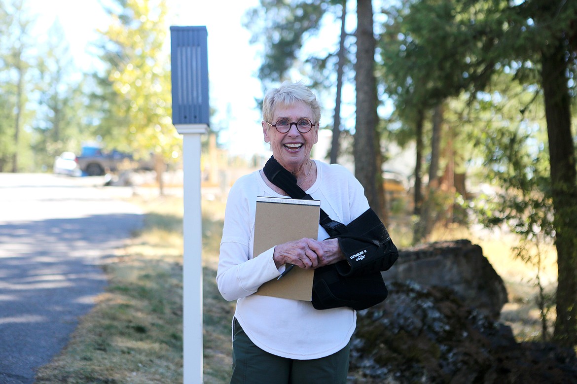 Lynn Woods, of Bigfork, smiles after thanking the crew from First Interstate Bank for clearing six bags worth of cheatgrass from her property. Woods, who was recovering from rotator cuff surgery, said their help was "a huge gift." (Mackenzie Reiss/Bigfork Eagle)