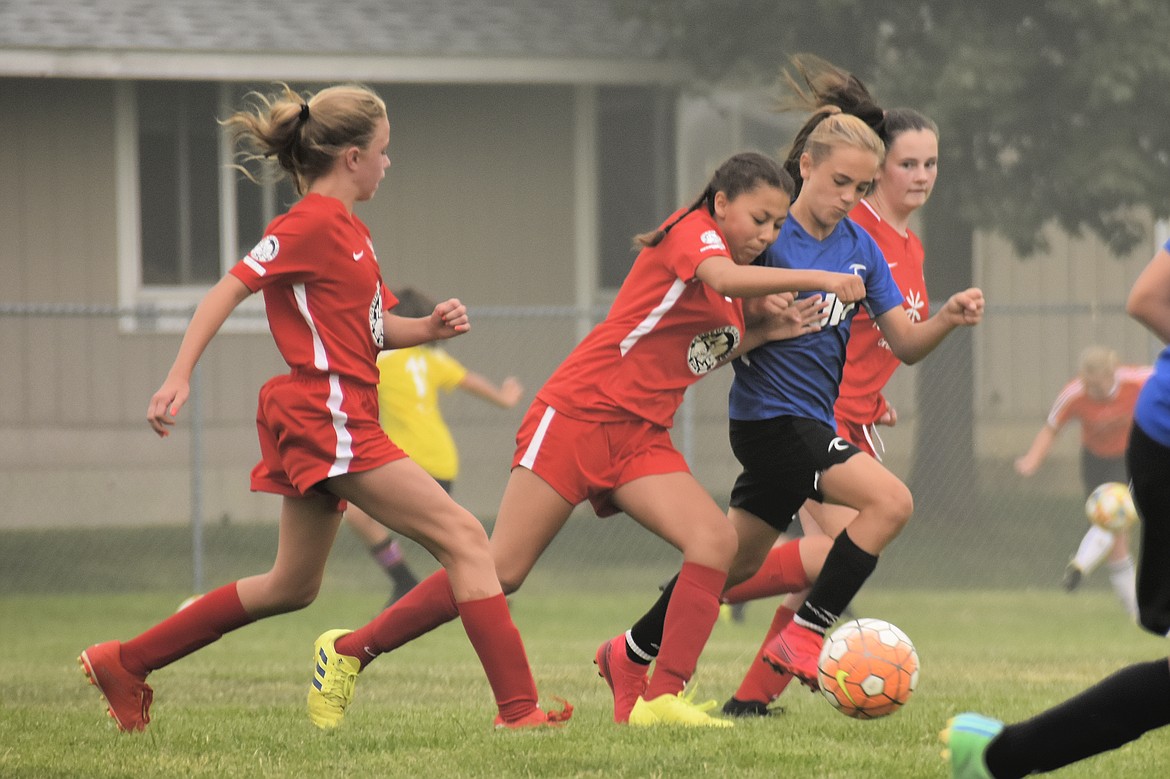Courtesy photo
This past weekend the Thorns North FC 08 Girls Red soccer team placed first in its bracket at the 2020 Pend Oreille Cup in Sandpoint before the hazardous air quality made it unsafe to play in the finals on Sunday. On Friday, TNFC 08G Red tied EW Surf SC 08G 4-4. Talia Lambro had one goal and two assists. Kamryn Kirk, Alli Carrico, Isabella Grimmett each had one goal. Adysen Robinson defended the goal for TNFC.
On Saturday TNFC 08G Red beat EW Surf SC 08G Royal 4-1. Avery Lathen had two goals. Talia Lambro and Ellie Moss each had one goal. Talia Lambro, Ella Pearson and Kamryn Kirk each had one assist. Macy Walters defended the goal for TNFC. Thorns, in red, pictured from left are Nora Ryan, Alli Carrico and Kambrya Powers.