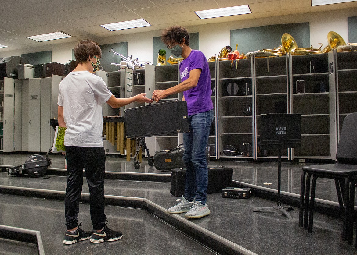 Moses Lake High School Band teacher Pablo Hernandez, right, hands off an instrument to freshman Brandon Harwood on equipment distribution day on Wednesday, Sept. 16.