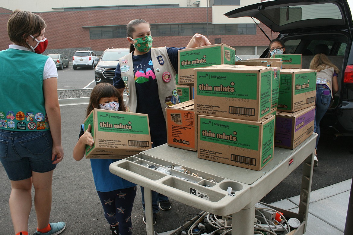 Cheryl Schweizer/Columbia Basin Herald

Girl Scouts, from the left, Ella, Madeline and Courtney unload Girl Scout Cookies for donation to Moses Lake Community Health on Wednesday.