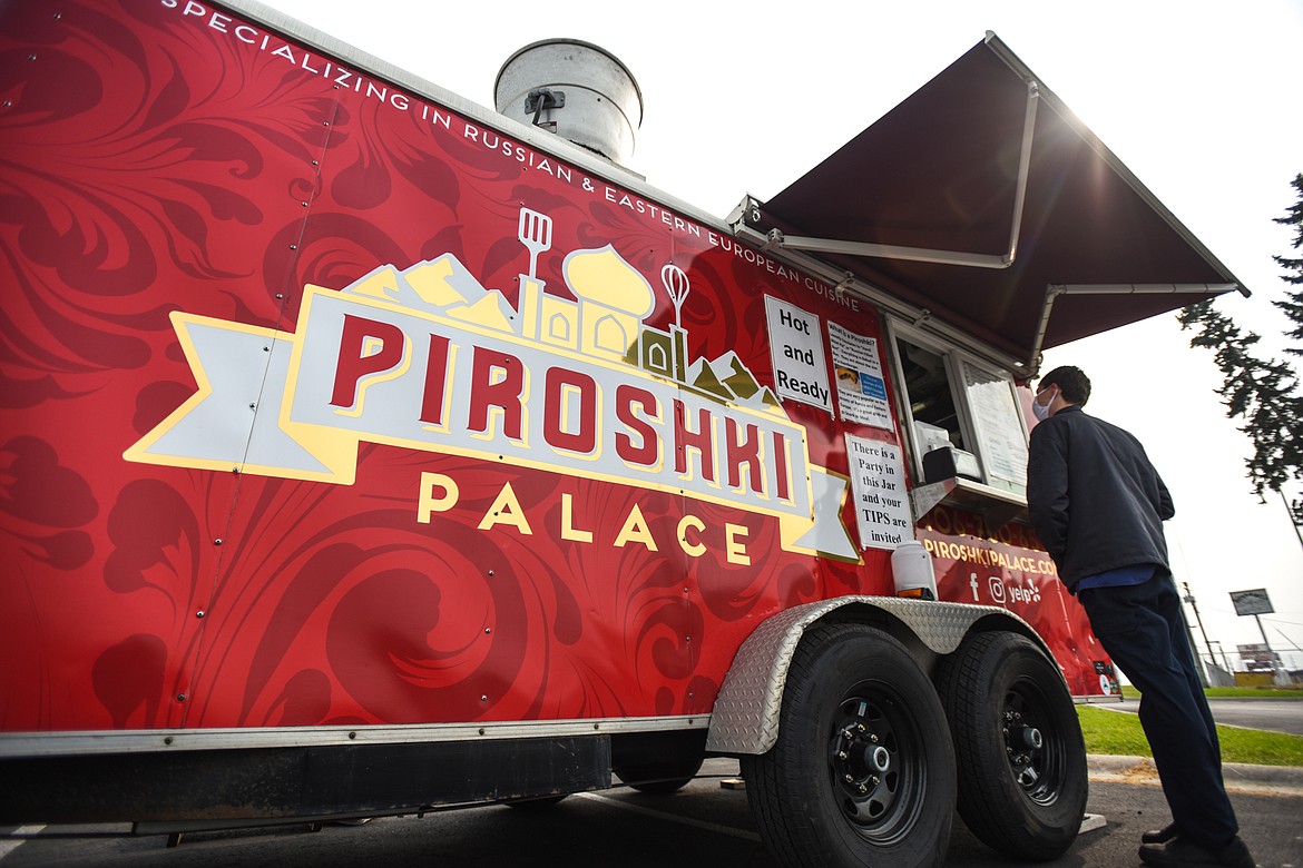 A customer orders from the Piroshki Palace food truck outside Smart Foodservice in Evergreen on Wednesday, Sept. 16. (Casey Kreider/Daily Inter Lake)