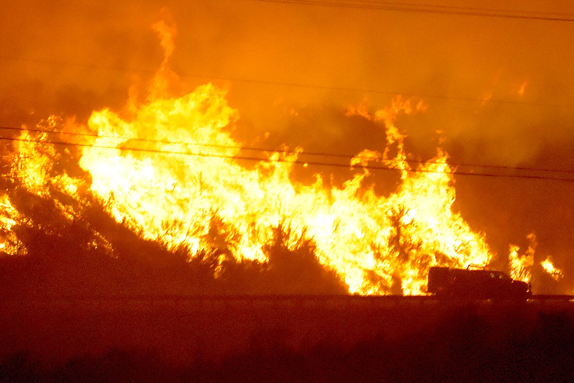Brock Hires, Omak-Okanogan County Chronicle/courtesy photo

A fire truck is silhouetted against the flames of the Cold Spring Canyon Fire as it burns along Highway 97 near Malott in Okanogan County Sept. 7. Donations are being sought for fire victims.