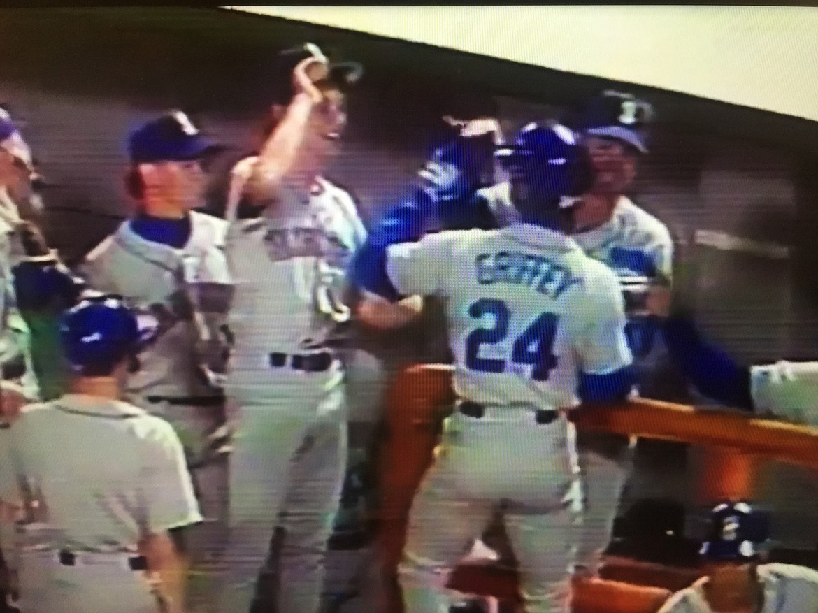 In this screen grab from video, Mariners batboy Matt Barkley prepares to high-five Ken Griffey Jr. after Junior followed his dad's homer with a historic one of his own in a Sept. 14, 1990 game vs. the California Angels in Anaheim, Calif.