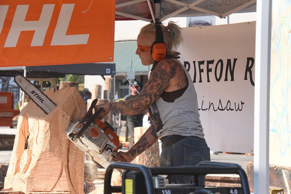 Griffon Ramsey, an Austin-based artist, works on her mermaid sculpture during the Kootenai Country Montana "Clash of the Carvers" event on Sept. 11. The chainsaw carving competition drew sculptors to Libby from around the globe.