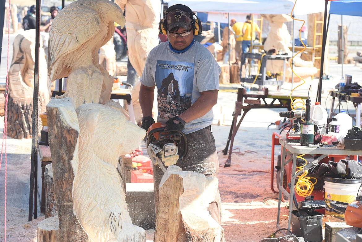 Fernando Dulnunan, an artist who immigrated to Oklahoma from the Philippines, works on his carving at the Kootenai Country Montana "Clash of the Carvers" event on Sept. 11. The chainsaw carving competition drew sculptors to Libby from around the world.
