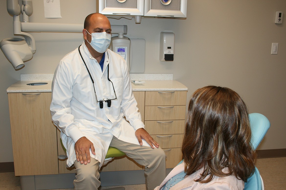 Moses Lake Community Health chief dental officer Brett Pack (background) said good dental health begins early in life.