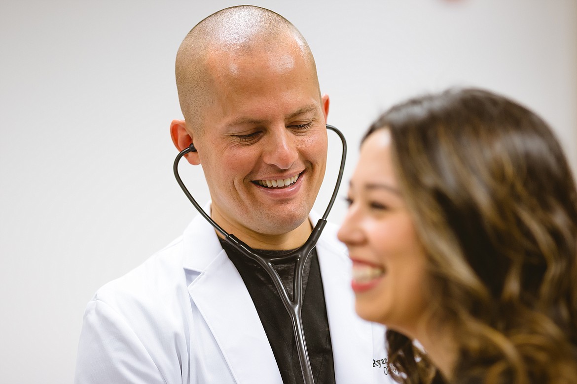 Physician Ryan Rasmussen. left, said women shouldn't neglect their health, even in stressful times.