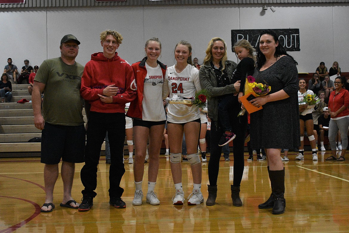 Kaylee Banks poses for a photo with her family on a Senior Night.