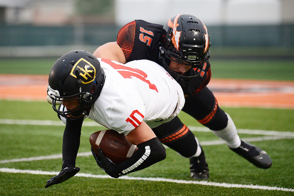 Flathead defensive back Ryan Nelson (15) brings down Missoula Hellgate’s Connor Dick (10) in the first quarter at Legends Stadium on Friday. (Casey Kreider/Daily Inter Lake)