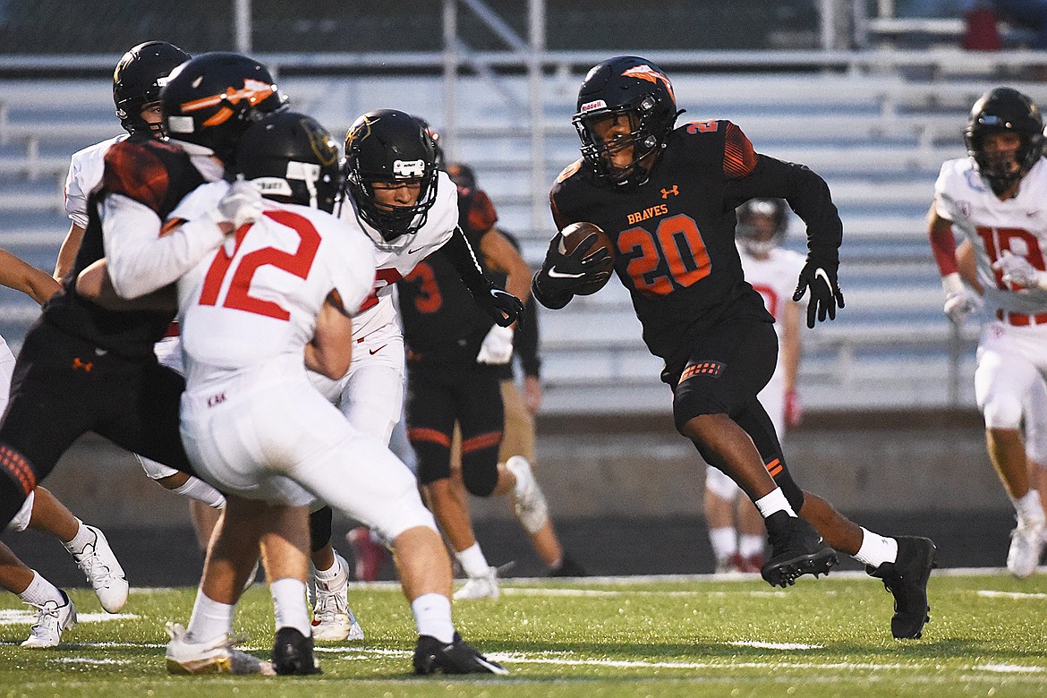 Flathead wide receiver Jackson Barrett (20) heads upfield after a first-half reception against Missoula Hellgate at Legends Stadium on Friday. (Casey Kreider/Daily Inter Lake)