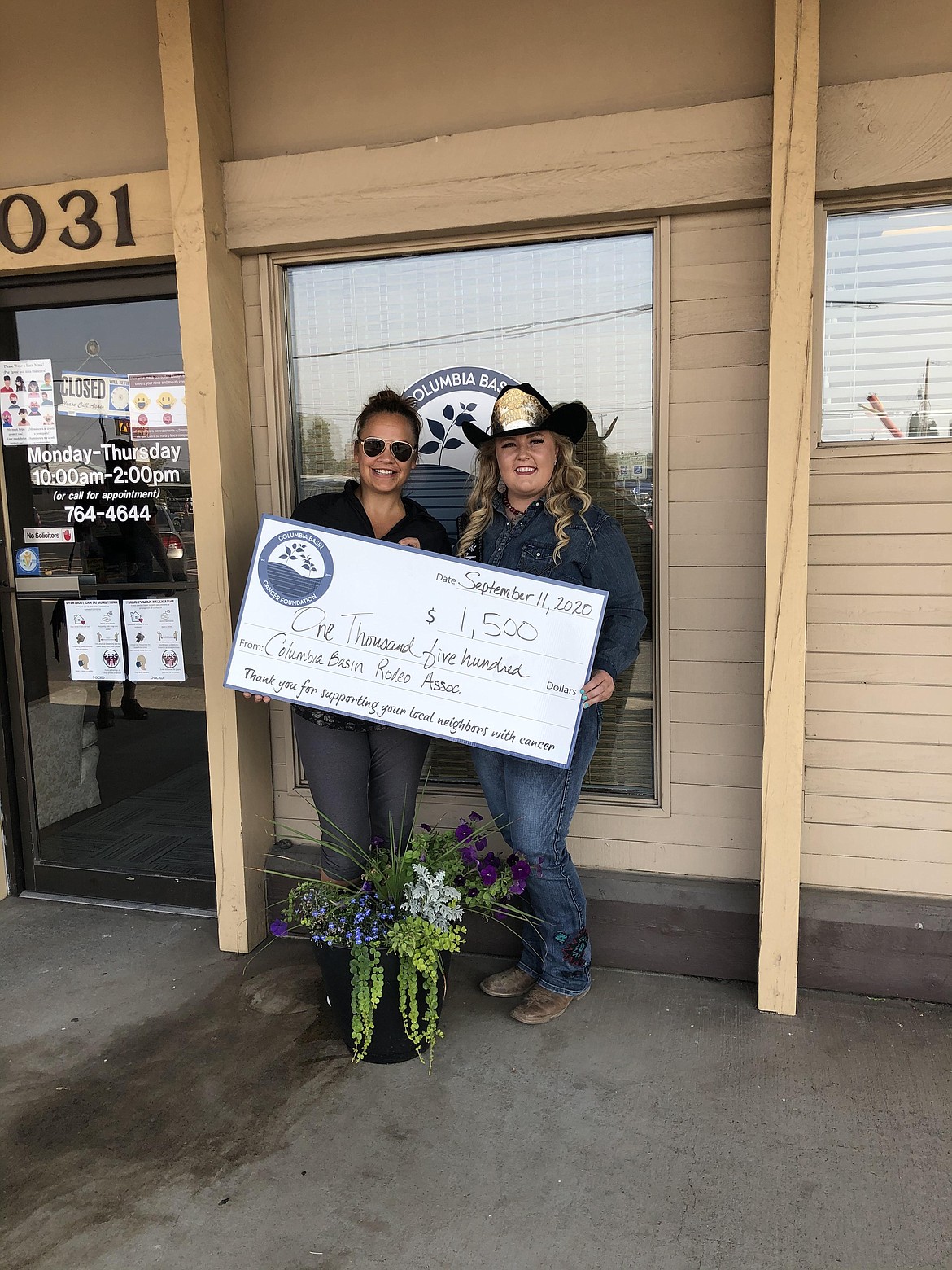 Mykiah Hollenbeck (right), 2020 Moses Lake Roundup queen, presents a check to Angel Ledesma of the Columbia Basin Cancer Foundation. The rodeo was canceled due to the coronavirus outbreak, but Hollenbeck has continued to perform her duties as queen.