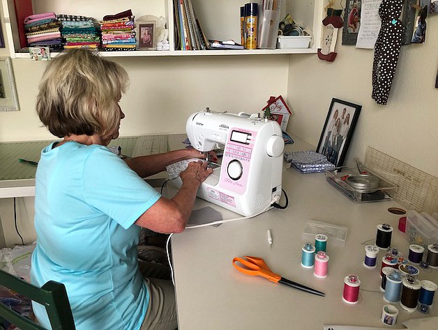 Lemons of Love Northwest co-founder Cathy Kobs and her colleagues donated nearly 1,100 face masks to three Coeur d'Alene schools this week. Kobs is seen here at her sewing machine, working hard to fill the need.