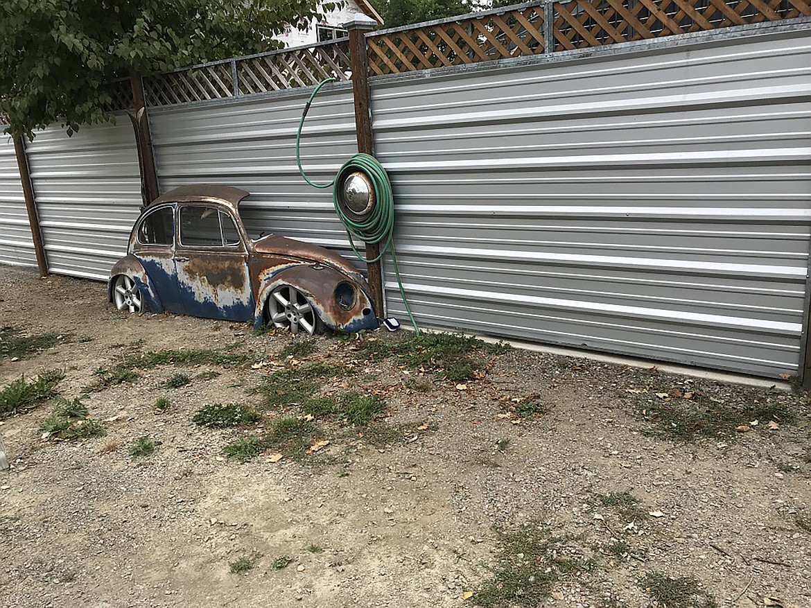 About a quarter of a Volkswagen has been a part of this fence line on North Monroe in Sandpoint for many years, what some call “a conversation piece” outside a local business near the library.