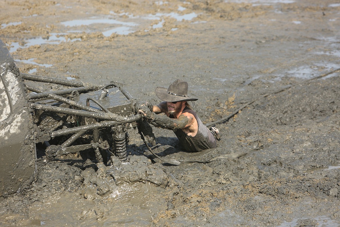 After Jeremy Bond's first-place performance Saturday, the towline to his vehicle came loose. A spectator leapt into the mud, skillfully waded out to "Nemesis," Bond's vehicle, and reattached the line to the back of his vehicle before pulling himself out of the waist-deep mud.