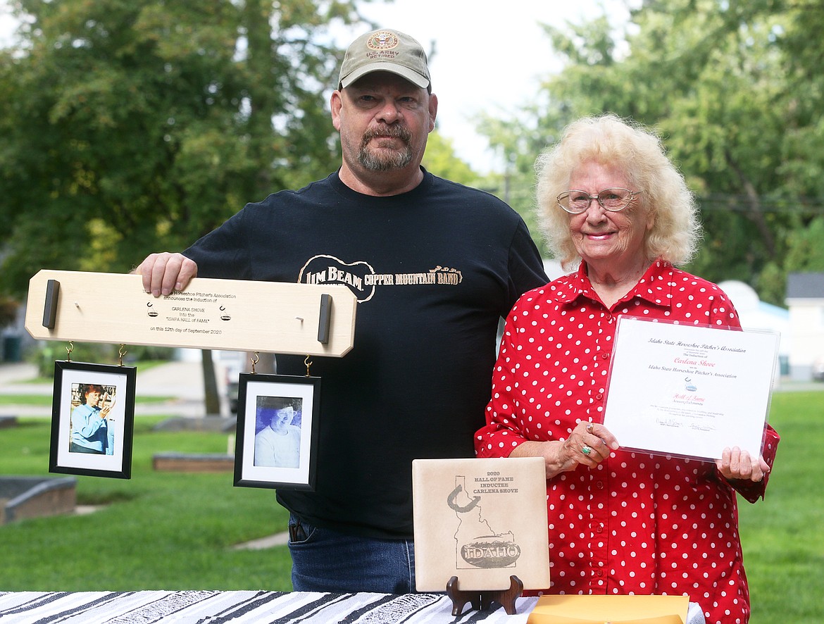 Carlena Shove and son Cliff Shove display her awards Sunday at Winton Park for being inducted into the Idaho State Horseshoe Pitchers Association Hall of Fame.