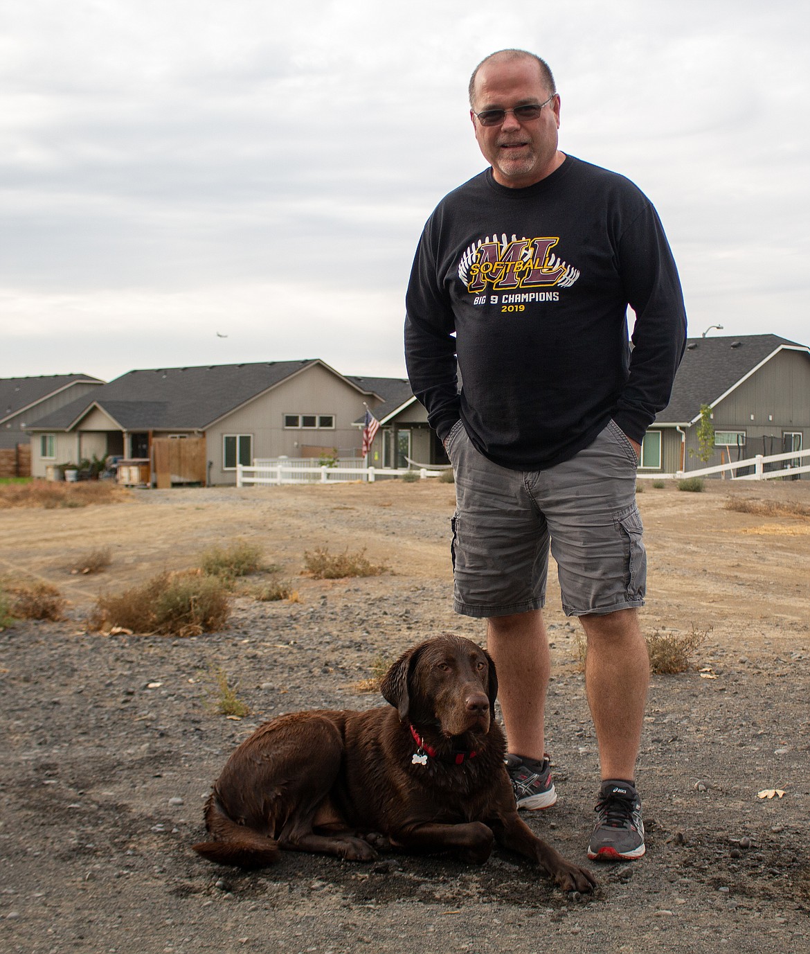 Chief Moses Middle School counselor Chris Mason spends some time with Brodi, his therapy dog and partner during the school year, after wrapping up the school day on Monday, Sept. 21, in Moses Lake.