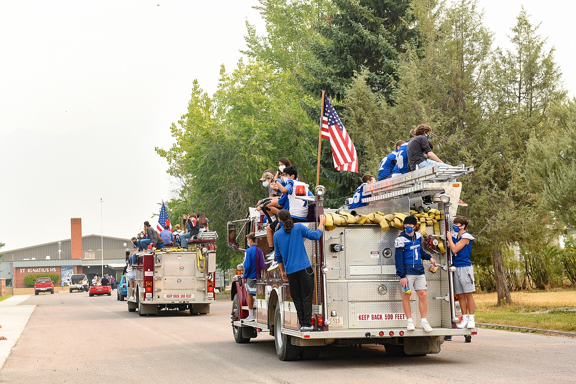 Students caught a ride from the St. Ignatius Fire Department during Friday's homecoming parade. (Christa Umphrey)