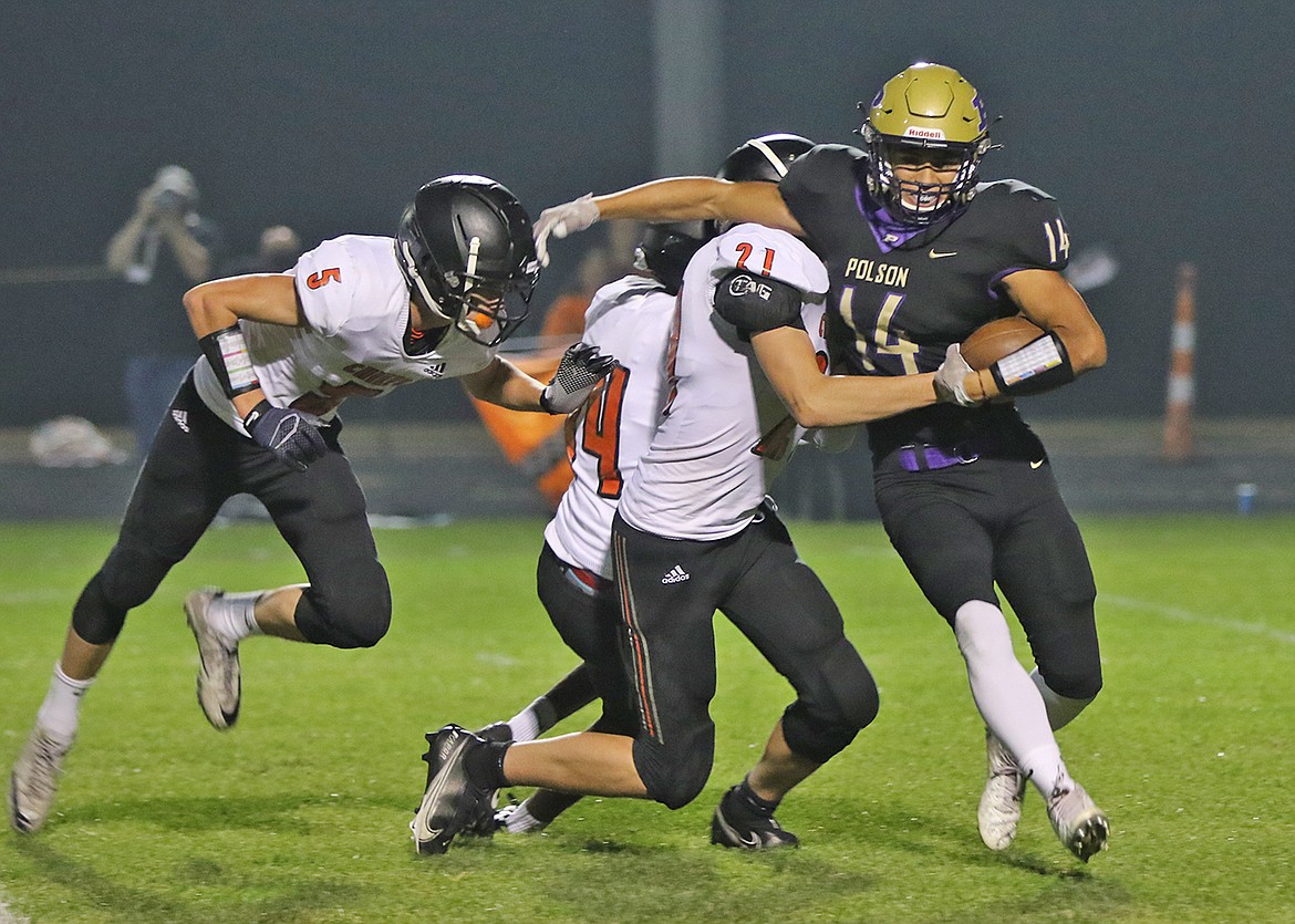 Ronan defenders Payton Cates (21), Trapper McAllister (5) and Owen Blixt Pirates' converge on the Pirates' Jony Perez (14). (Bob Gunderson)