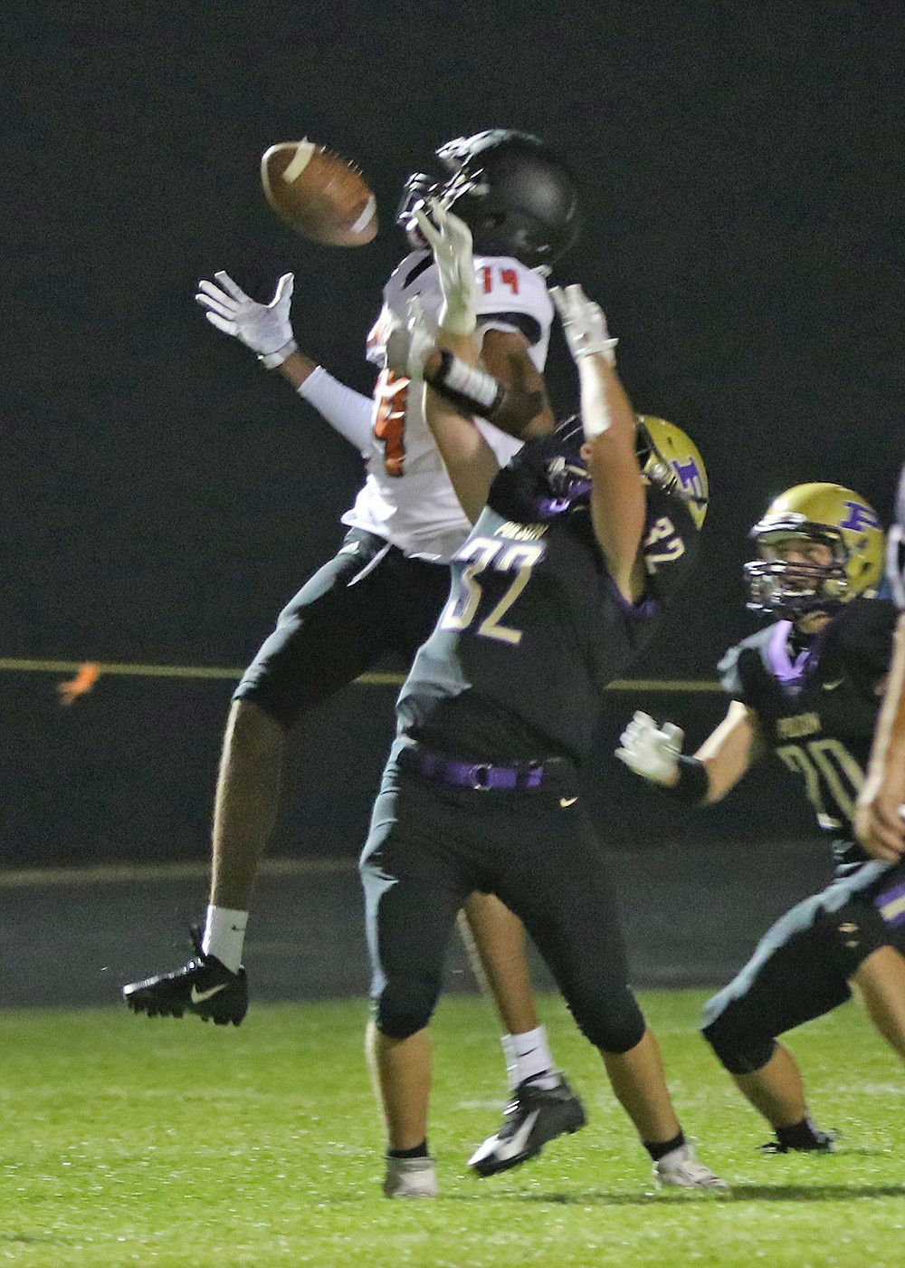 Trent Wilson (32) breaks up a pass intended for Ronan's Girma Detwiler (14) in front of Xavier Fisher (20). (Bob Gunderson)